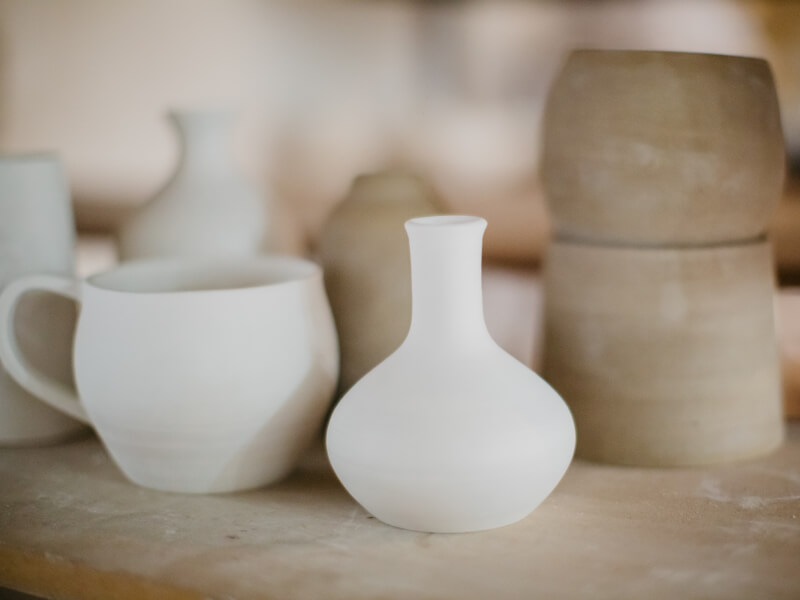 Unglazed ceramic objects on a shelf